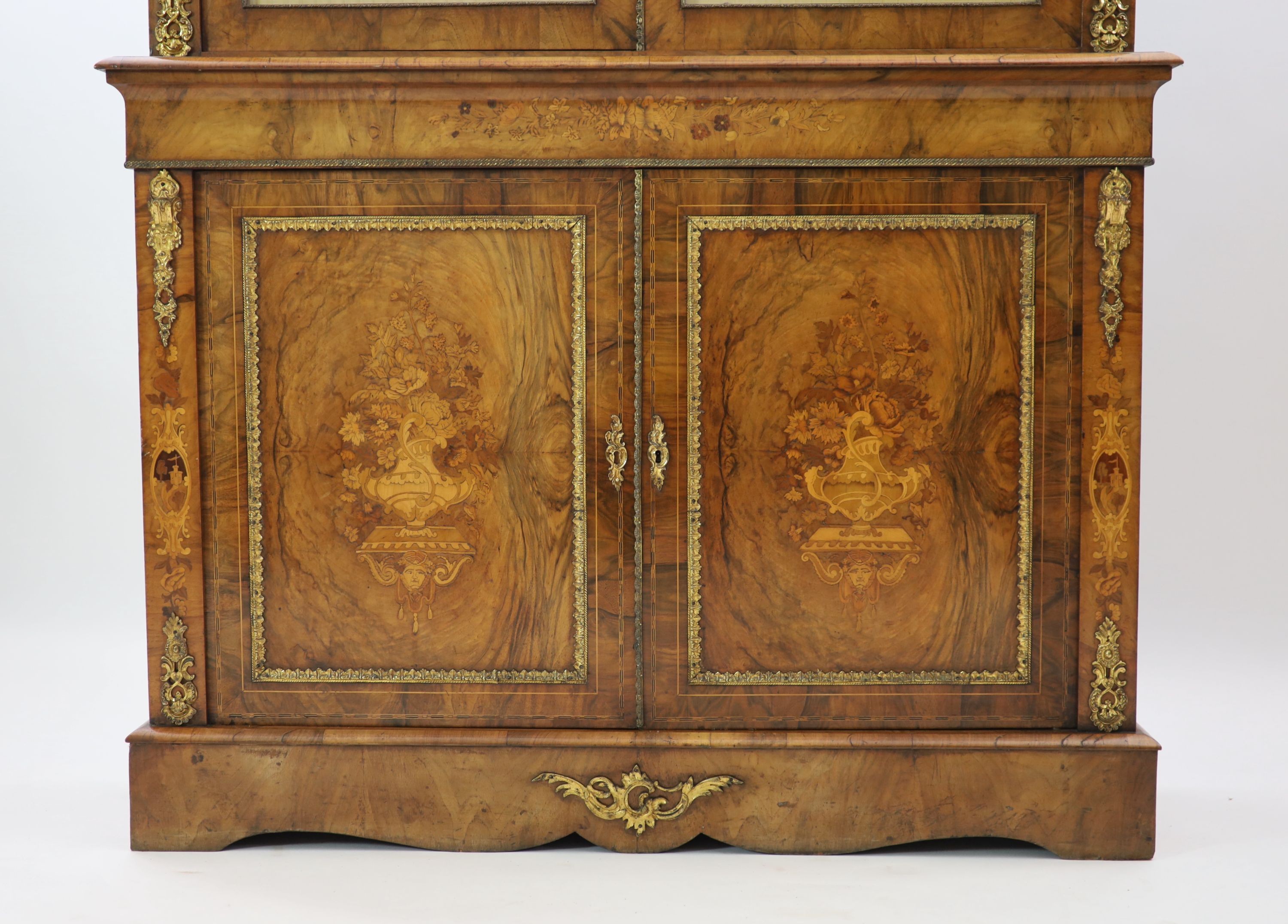 A Victorian ormolu mounted marquetry inlaid walnut bookcase, W.127cm D.40cm H.208cm